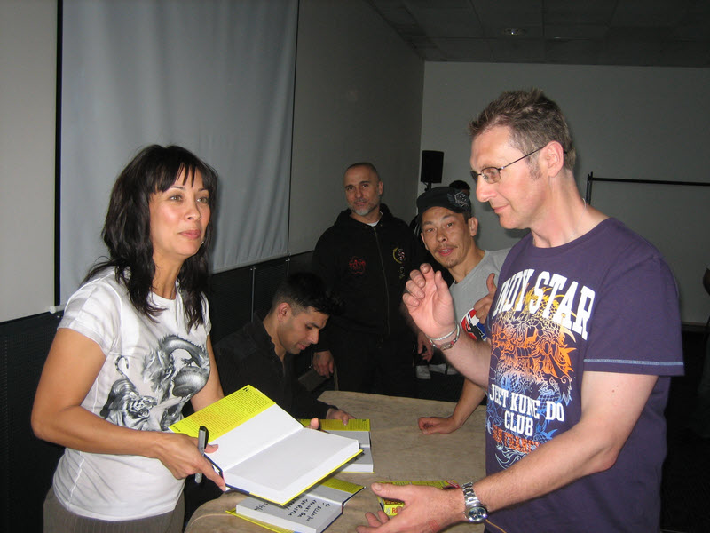 Backstage with Diana Lee Inosanto signing books, Fiaz Rafiq seated beside her