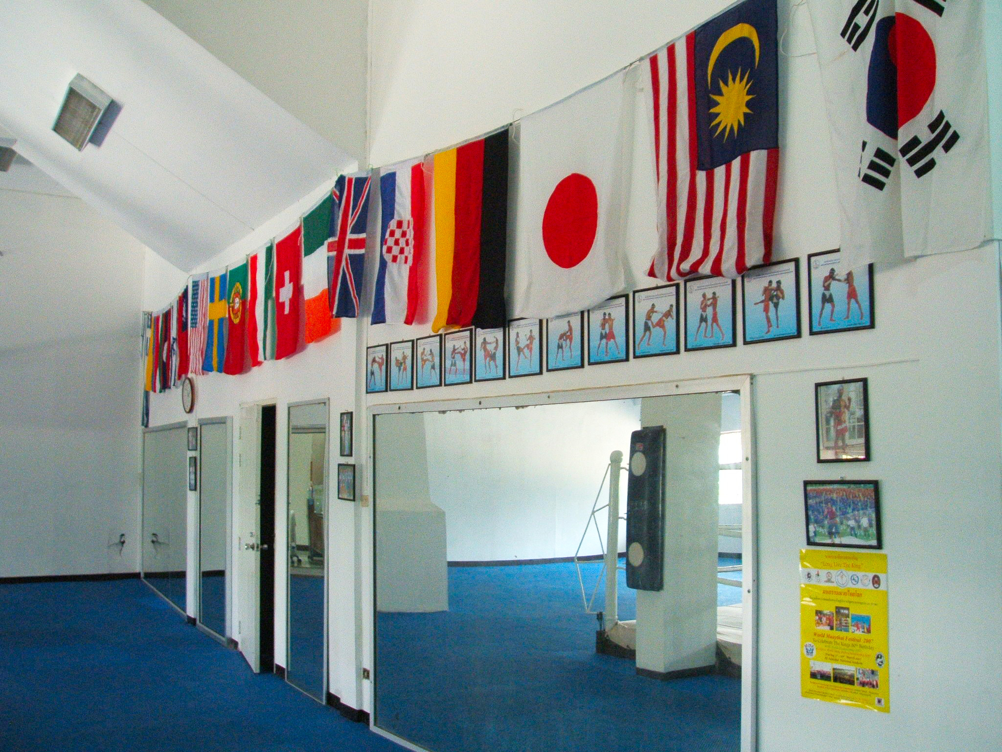 Inside Bangkok National Stadium Complex showing flags of dozens of nations hanging from the walls - Japan, Malaysia, Korea, Germany, Croatia, USA, UK and more