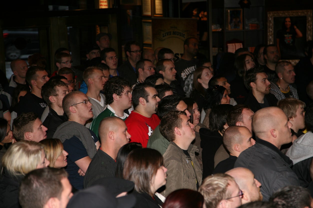 Packed crowd seated and watching intently at the Scotland event