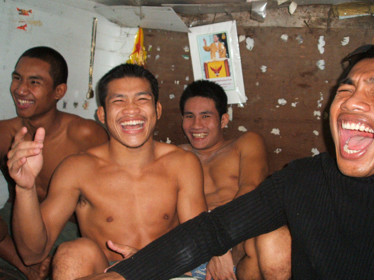 Fighters laughing with royal portrait behind
