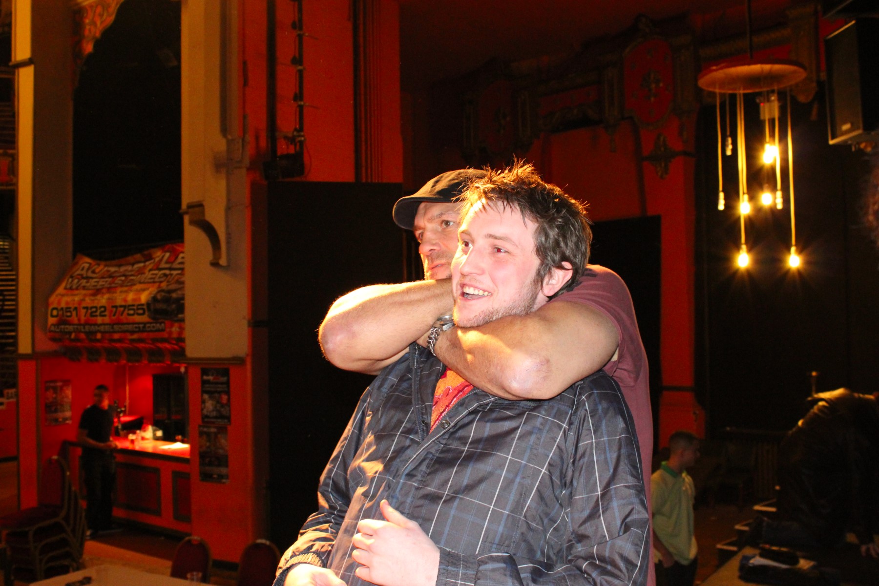 Randy Couture playfully putting a fan in a rear naked choke at Liverpool Olympia