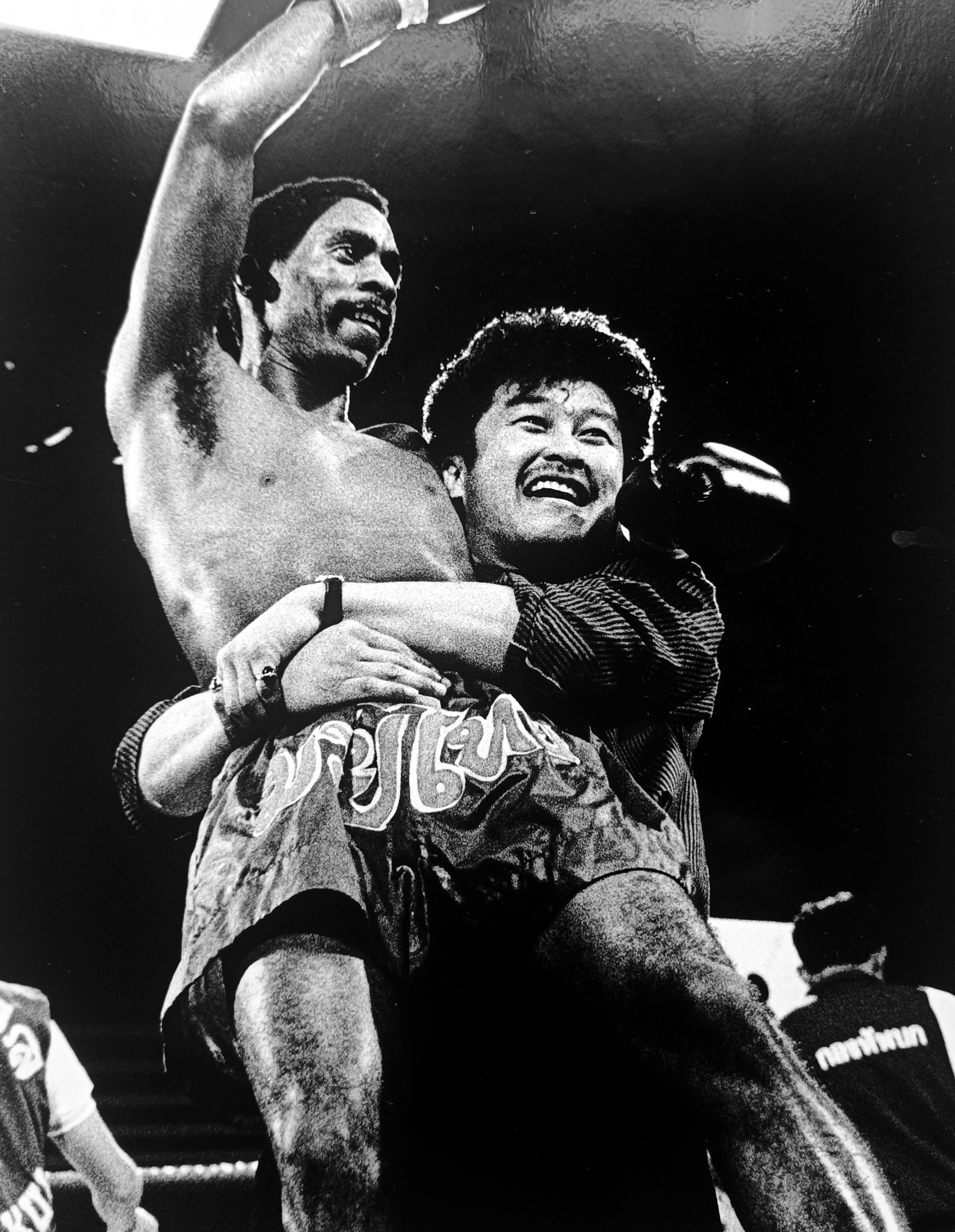 Ronnie Green lifted in victory by his Thai corner man, both celebrating with pure joy