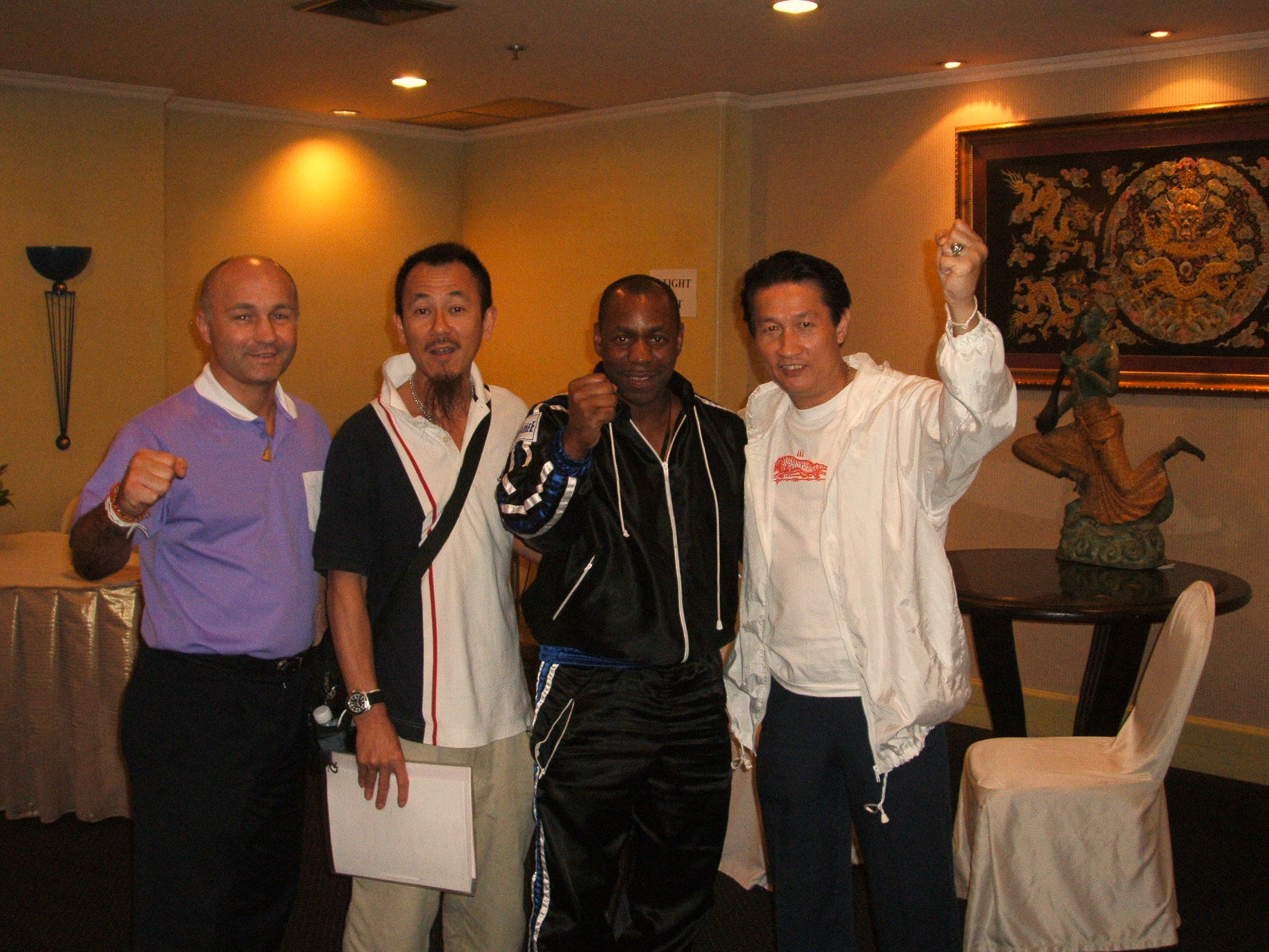 Ralph Kussela from Germany, two Hong Kong martial artists, and Ronnie Green, with an ex-Hong Kong Police Detective, dragon embroidery behind them