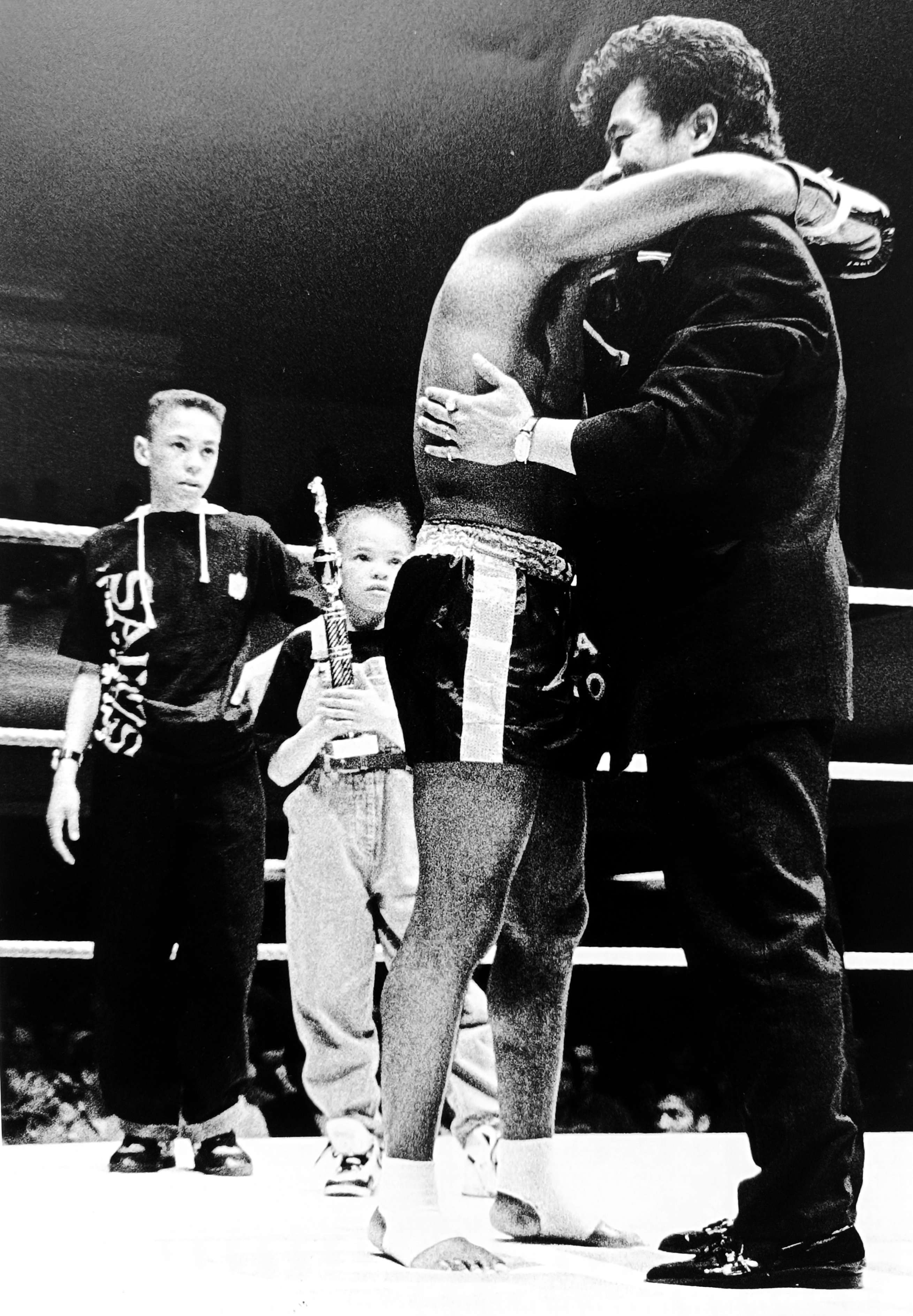 Master Toddy hugs Ronnie while his children celebrate